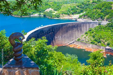 Lake Kariba dam wall and a statue of nyami nyami the river snake god. Zambezi river. Zimbabwe ...