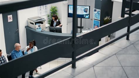 Lady Receptionist Working at Hospital Reception Desk To Help Patients ...