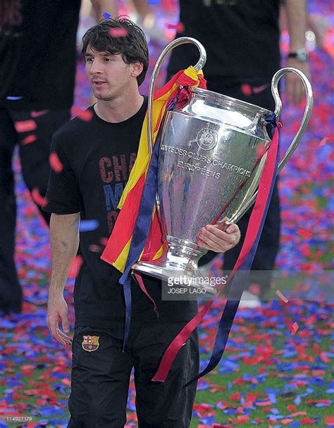 Barcelona's Argentinian forward Lionel Messi holds the UEFA Champions League trophy during a ...