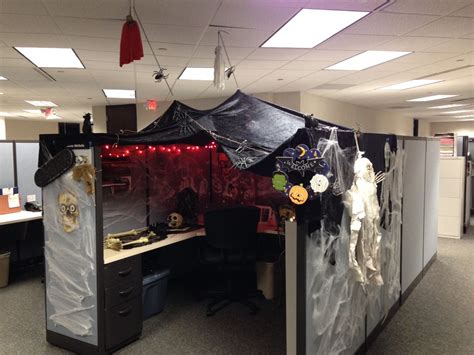 an office cubicle decorated for halloween with decorations on the walls ...