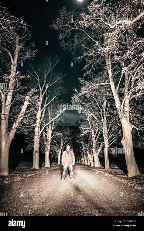 Scary horror person standing in night landscape Stock Photo - Alamy