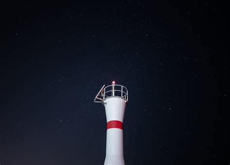 A Lighthouse under a Starry Night Sky · Free Stock Photo