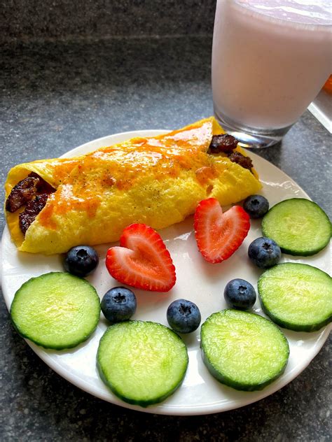 Cheesy Italian sausage omelette with cucumber, strawberries and ...