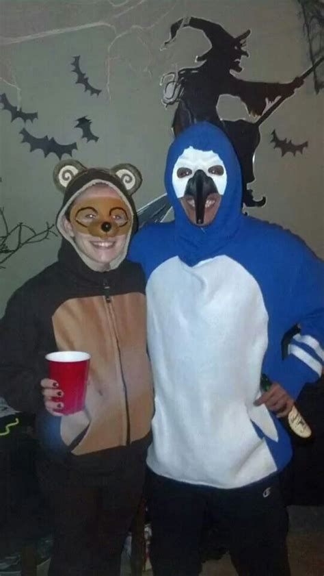 two people in animal costumes standing next to each other and holding ...