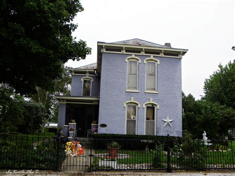 a blue house with white trim and windows