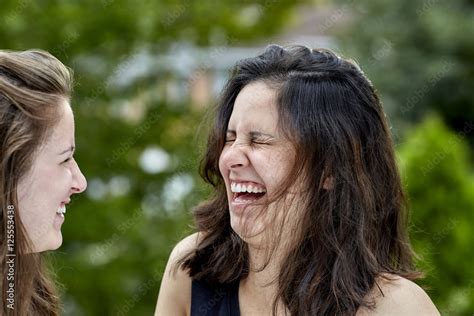 Two Girls Laughing Together Stock Photo | Adobe Stock