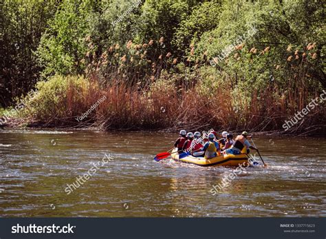 Rafting at mountain river. Group of tourists in the inflatable raft ...