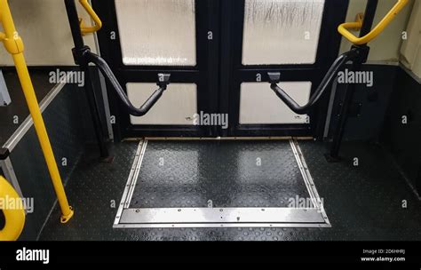 Bus door with yellow handles, interior view. The mechanism for opening and closing the doors of ...