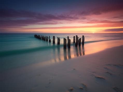 Premium AI Image | A beach with a purple sky and a cloudy sunset.