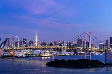 Premium Photo | Sunrise Tokyo tower and Rainbow bridge