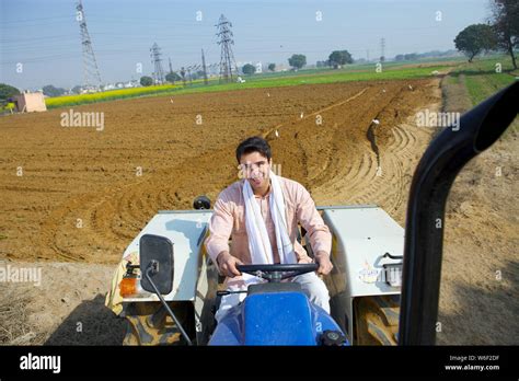 Farmer ploughing field Stock Photo - Alamy