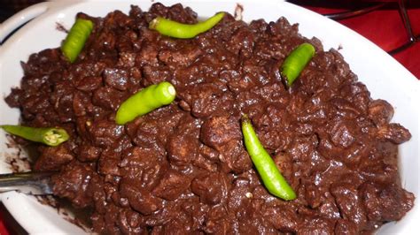 a white plate topped with meat and green peppers