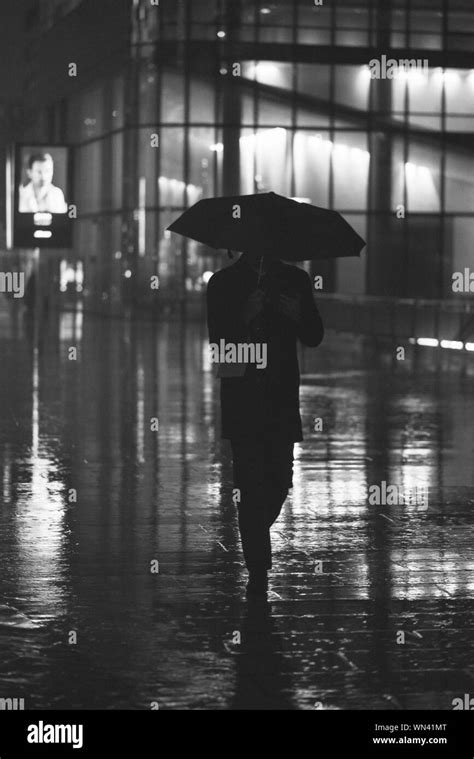 Man walking rain umbrella hi-res stock photography and images - Alamy