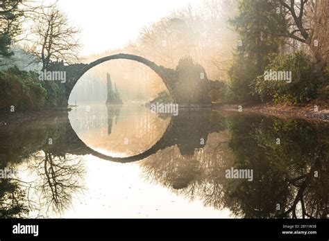 The Rakotzbrücke in the Rhododendronpark Kromlau at sunrise, Gablenz ...