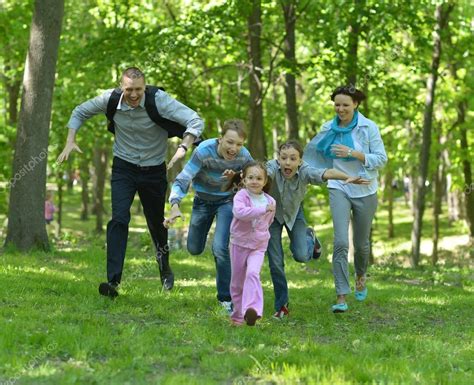 Family walking in park Stock Photo by ©aletia 47820477