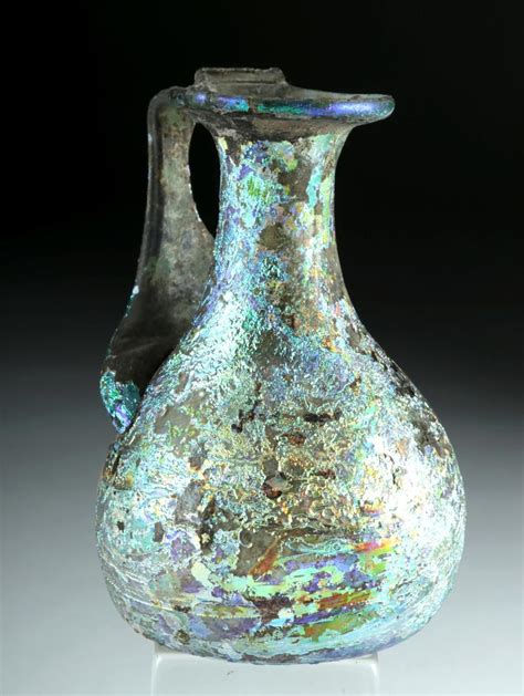 Sold at Auction: Roman Glass Pitcher w/ Stunning Iridescence | Roman glass, Antique glass, Antiques