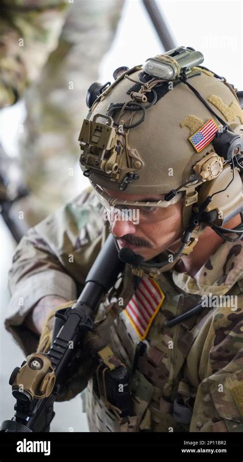 A U.S. Coast Guard Maritime Security Response Team East member participates in a live fire ...