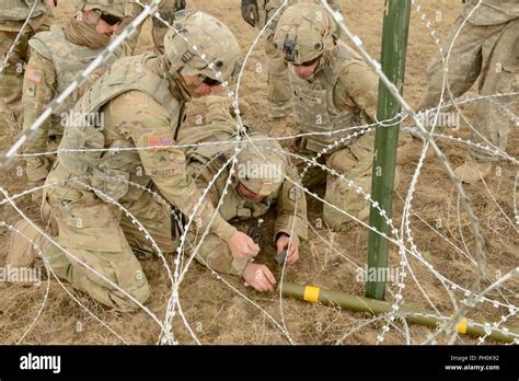 Pfc. Andrew Taylor of Army Reserve’s 321st Engineer Battalion primes a ...