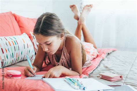 Pre teen girl writing diary Stock Photo | Adobe Stock