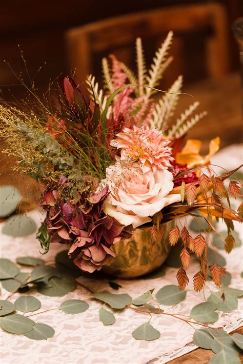 Fall Foliage and Flower Centerpiece in Gold Vase