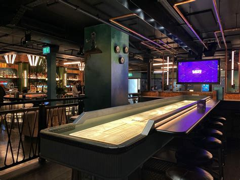 Electric Shuffle | A New Tabletop Shuffleboard Bar From Flight Club