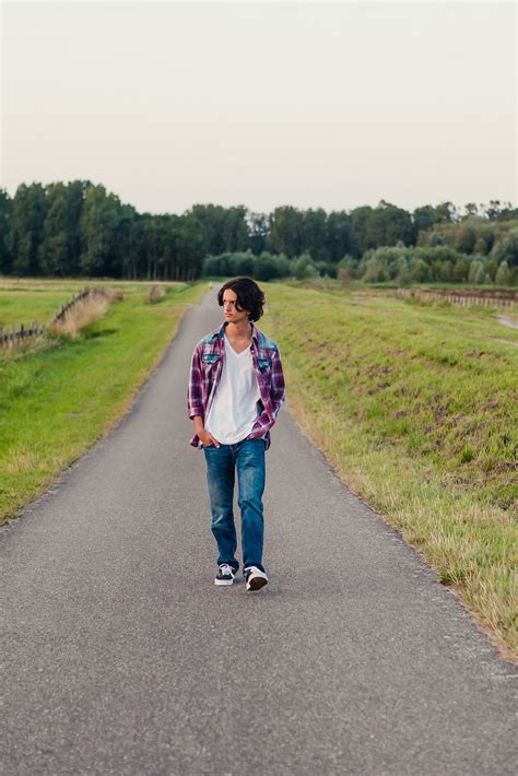 "Teenage Boy Walking On A Long Road In The Fields" by Stocksy Contributor "Cindy Prins" - Stocksy