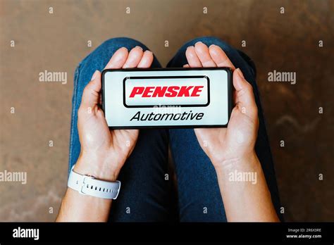 In this photo illustration, the Penske Automotive Group logo is ...