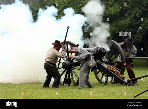 Confederate soldiers firing a cannon during a battle at a Civil War Encampment Reenactment Stock ...