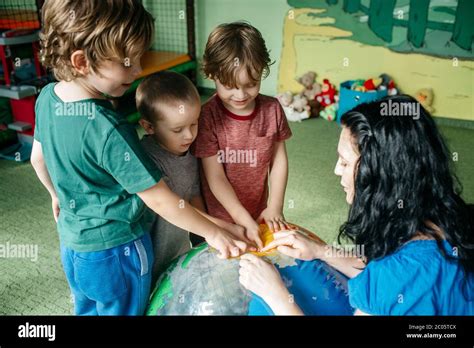 Children learning about countries with an inflatable globe ball Stock ...