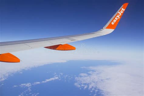 The Wing and Winglets of an Airbus A320 Commercial Airliner with a Company Logo while in Flight ...