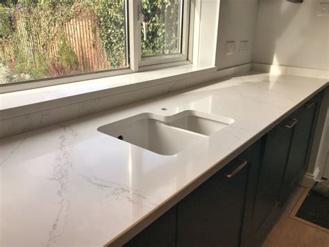 Installation of Eternal Calacatta Gold Silestone worktops, with full height splashback, Blanco Z ...