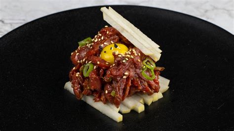 Download Gourmet Steak Tartare Dish with Spices and Accompaniments Wallpaper | Wallpapers.com