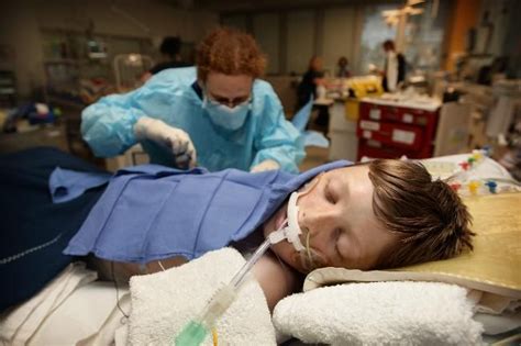 Inside ICUs from around the world... a nurse performs a sterile procedure on a young intubated ...