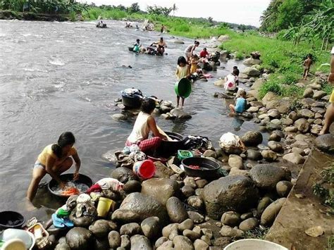 Washing clothes in the river. | Washing clothes, River, Village life