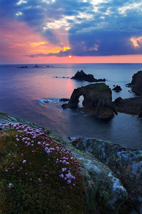 A view of Lands End at sunset with Longships Lighthouse in the distance. | Sunset, Lighthouse ...