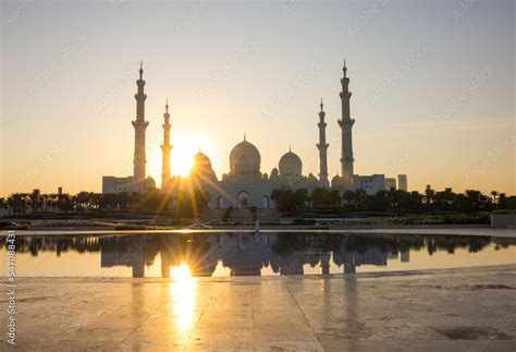 Tourists visit the Sheikh Zayed Grand Mosque. Night time view opposite ...