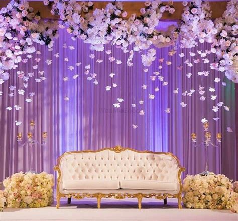 Photo of Elegant stage backdrop with hanging floral strings in white