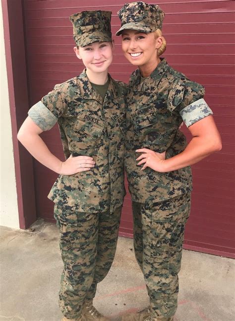 two women in army fatigues standing next to each other