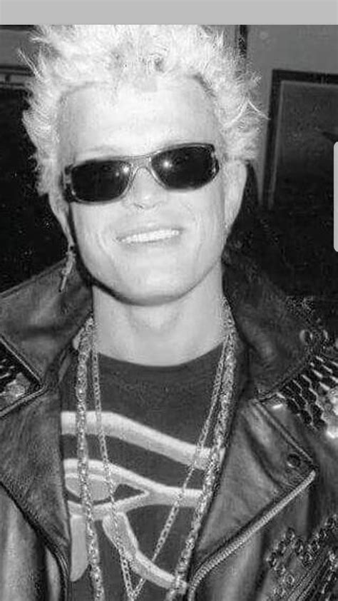 a man with white hair wearing sunglasses and a leather jacket