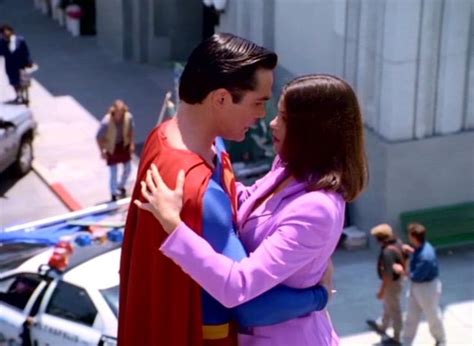 a man in a superman costume hugging a woman