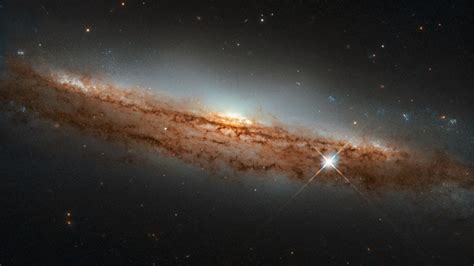 NASA, ESA Hubble telescope captures image of spiral galaxy 60 million light-years away – Firstpost