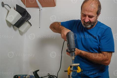 carpenter craftsman drilling wood with an electric drill 10967989 Stock Photo at Vecteezy