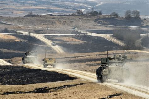 Soldiers maneuver vehicles during a combined-arms live-fire exercise at ...