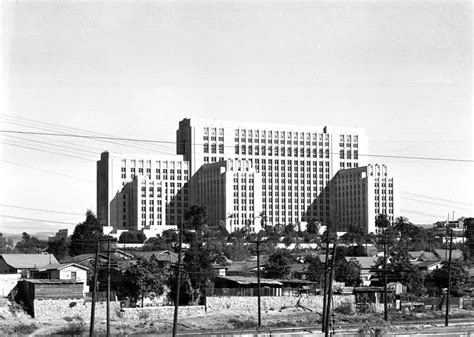 Exterior view of Los Angeles County Hospital Acute Unit in April 1939. Houses are in the ...