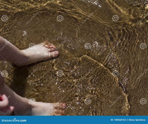 Baby feet walking on water stock image. Image of sand - 148568163