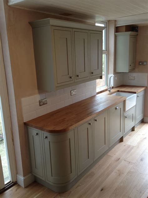 Sage green kitchen (Benchmarx range) with treated oak work surface and Belfast sink. Victorian ...