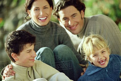 Family laughing together outdoors - Stock Photo - Dissolve