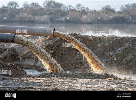 industrial effluent, pipeline discharging liquid industrial waste into a river Stock Photo - Alamy