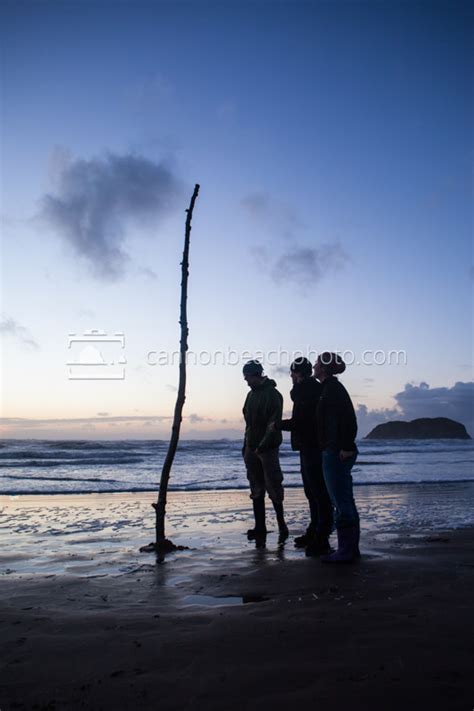 Three People Observe Beach Art - Cannon Beach Photo