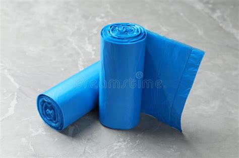 Rolls of Light Blue Garbage Bags on Grey Marble Table Stock Image - Image of chore, environment ...